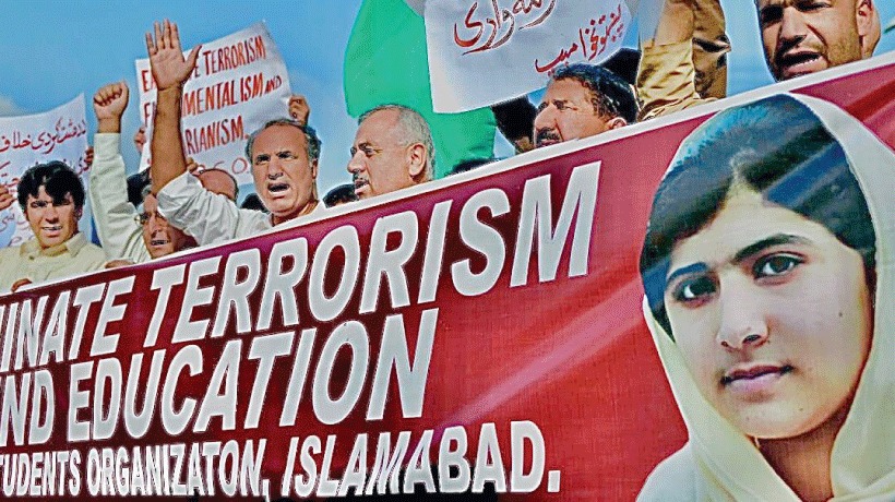 "Protest in Islamabad with Malala Yousafzai banner against terrorism and for education."